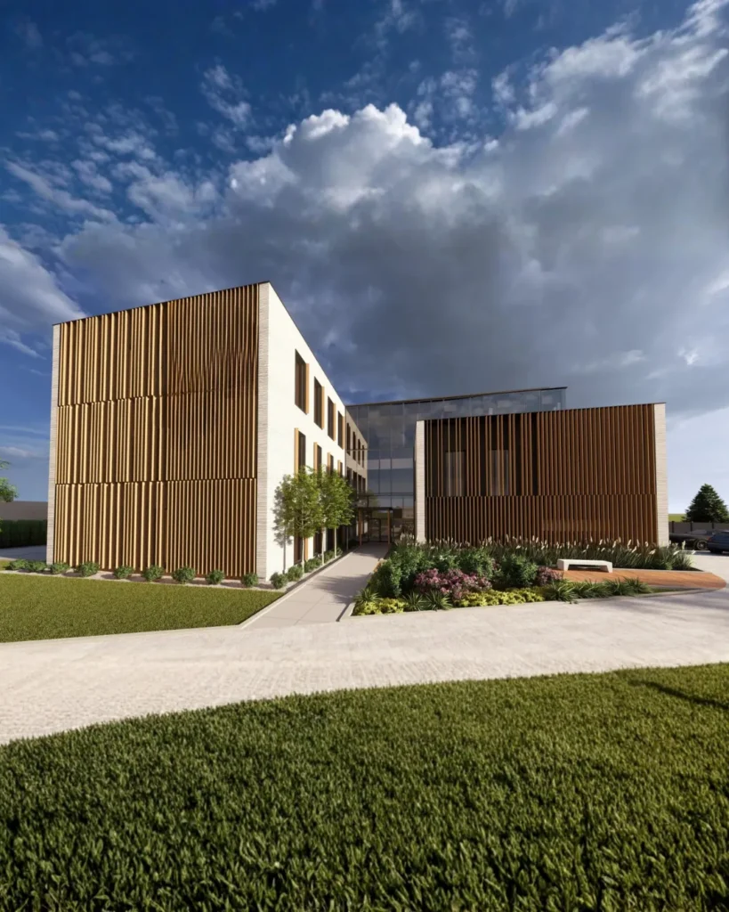 Nowoczesny kompleks biurowo-przemysłowy z elewacją z pionowych lameli i minimalistyczną bryłą architektoniczną. Widok narożny na budynek z parkingiem, zielenią oraz reprezentacyjną strefą wejściową utrzymaną w nowoczesnym stylu premium.